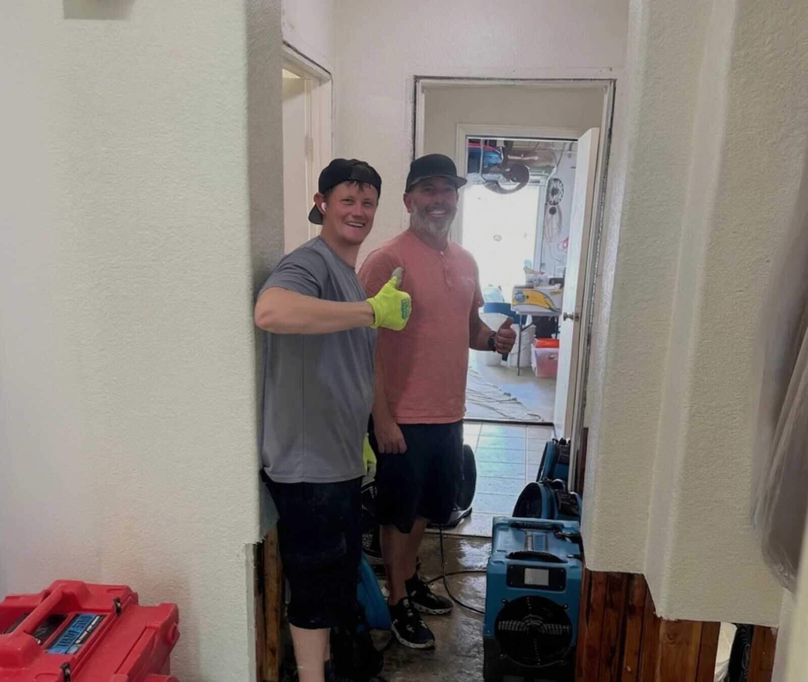 Local water damage restoration crew on the job at an Austin-area home, air movers and dehumidifier running